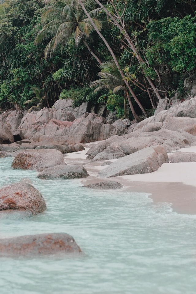 Photo of a rock laden beach at Perhentian Islands.