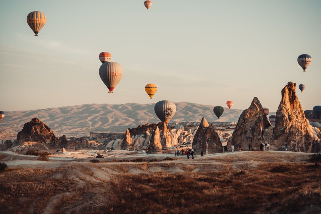 Best places to visit in Turkey Number 1 - Hot air balloons at Cappadocia with mountains in the backdrop.