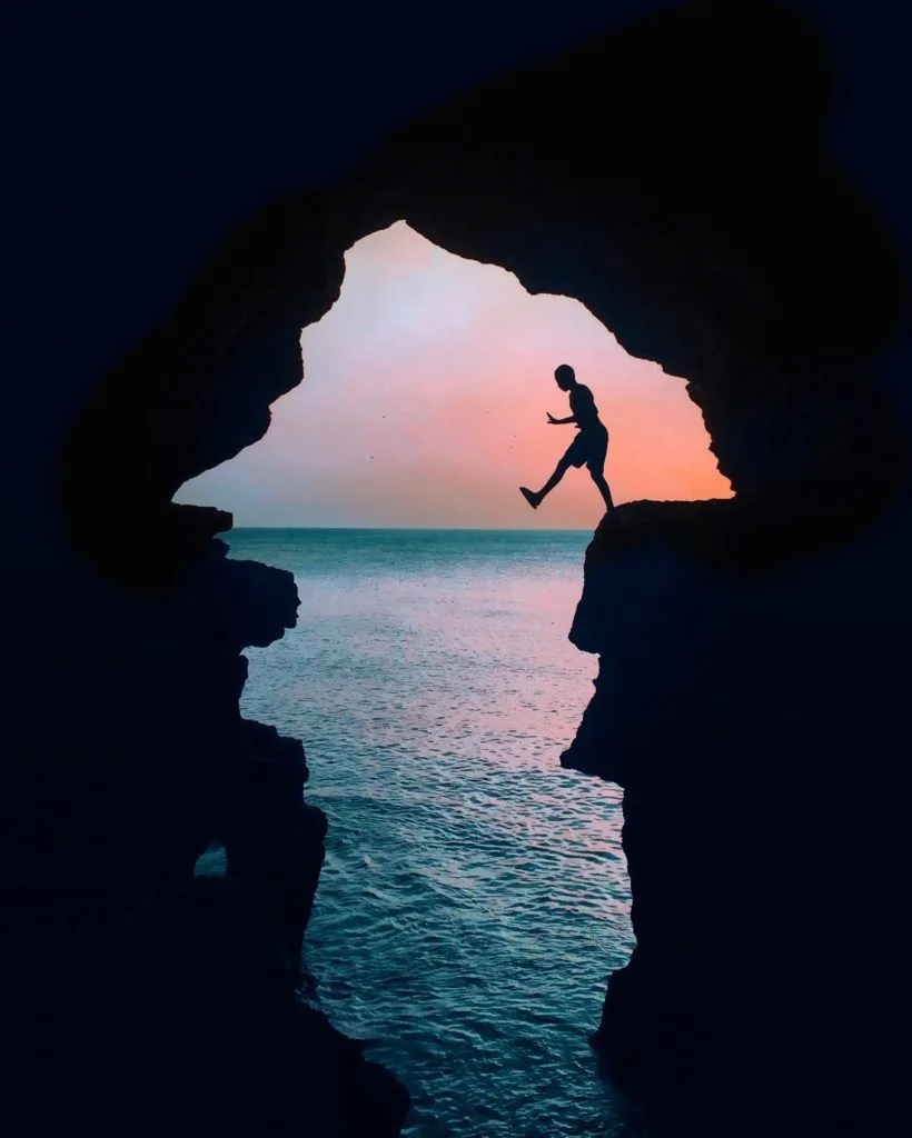 Person jumping at Hercules Cave